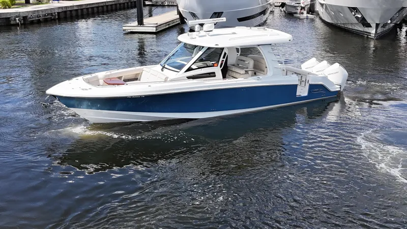 Slide: The Image of 2020 Boston Whaler 350 Realm boat cruising in a marina. - 8