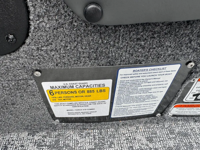 Slide: The Image of Capacity and safety checklist on 2026 Tracker Targa V-18 Combo boat interior. - 10