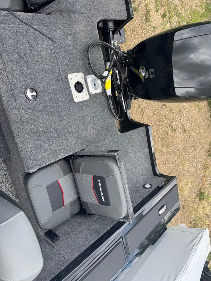 Slide: The Image of 2026 Tracker Targa V-18 Combo boat interior with seats and motor, showcasing modern design. - 16