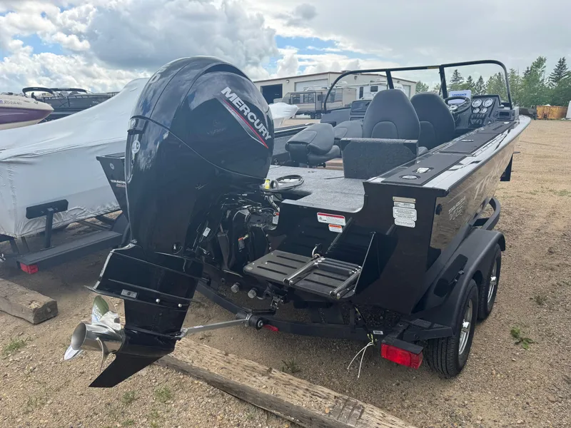 Slide: The Image of 2026 Tracker Targa V-18 Combo boat with Mercury outboard motor, parked on a trailer. - 3