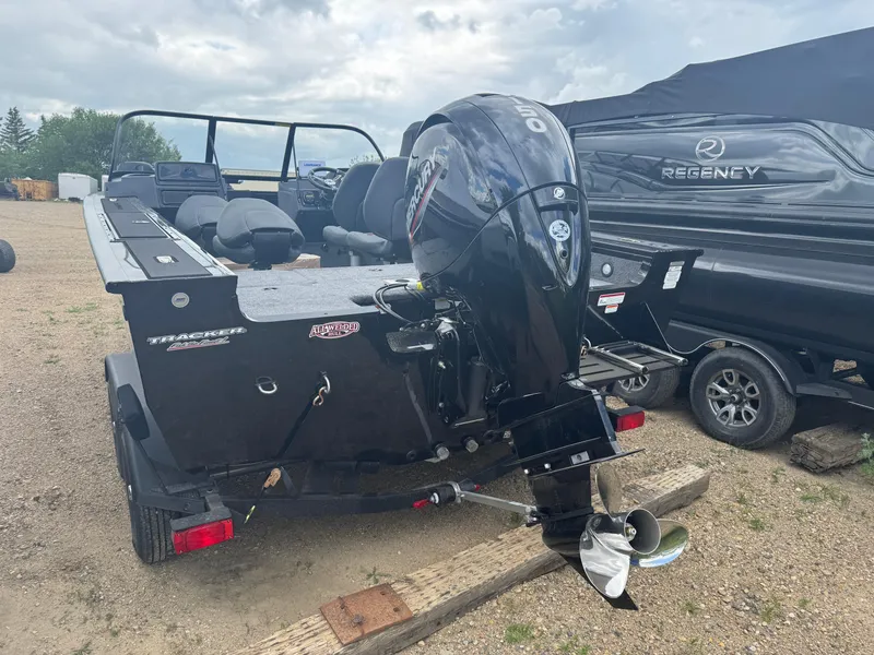 Slide: The Image of 2026 Tracker Targa V-18 Combo boat with powerful outboard motor, parked on gravel. - 4
