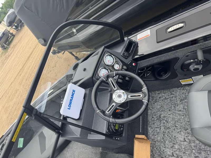 Slide: The Image of 2026 Tracker Targa V-18 Combo boat dashboard with steering wheel and Lowrance device. - 8