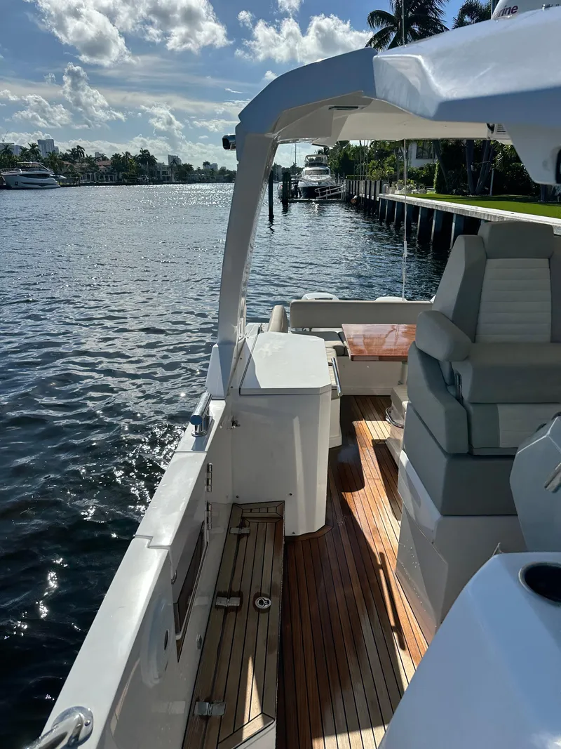 Slide: The Image of 2018 Azimut Verve 40 yacht with sleek deck, cruising on a sunny waterfront. - 16