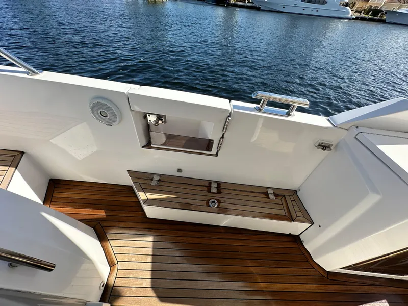 Slide: The Image of 2018 Azimut Verve 40 yacht deck with wooden flooring and water view. - 21