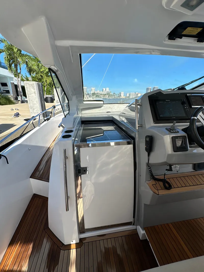 Slide: The Image of 2018 Azimut Verve 40 yacht cockpit with modern controls and wooden flooring. - 23