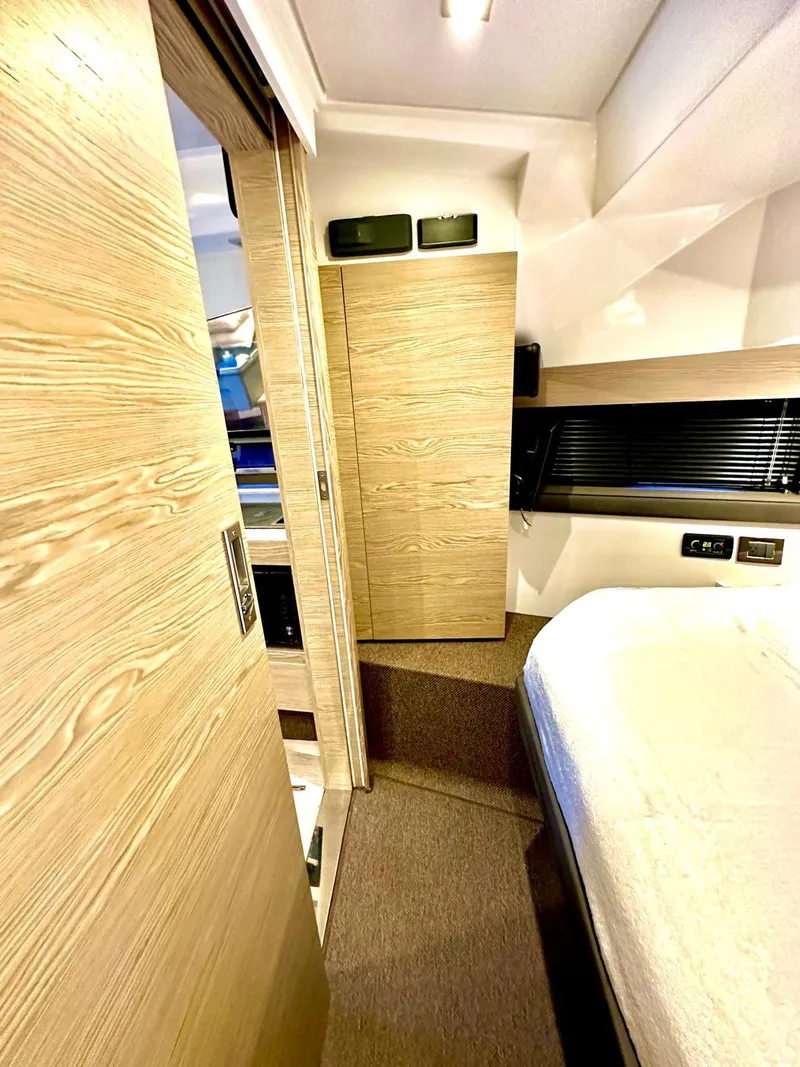 Slide: The Image of Interior of 2018 Azimut Verve 40 yacht, featuring modern wood finishes and cozy sleeping area. - 36