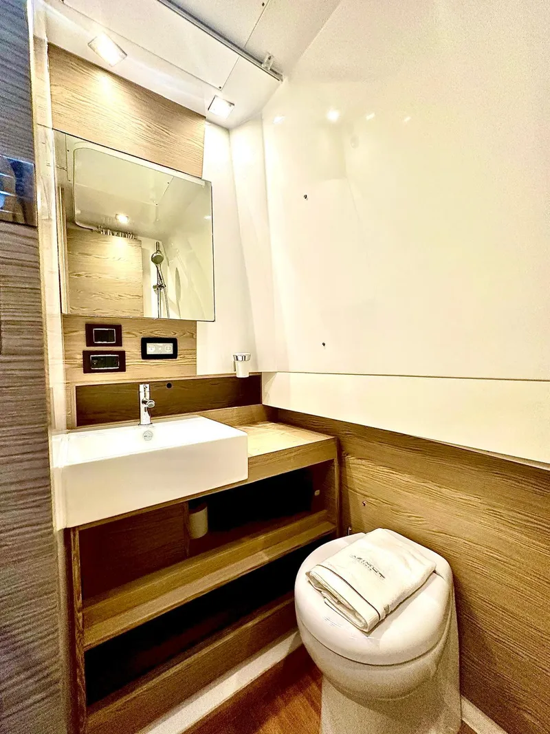Slide: The Image of 2018 Azimut Verve 40 yacht bathroom with modern sink, mirror, and toilet. - 37