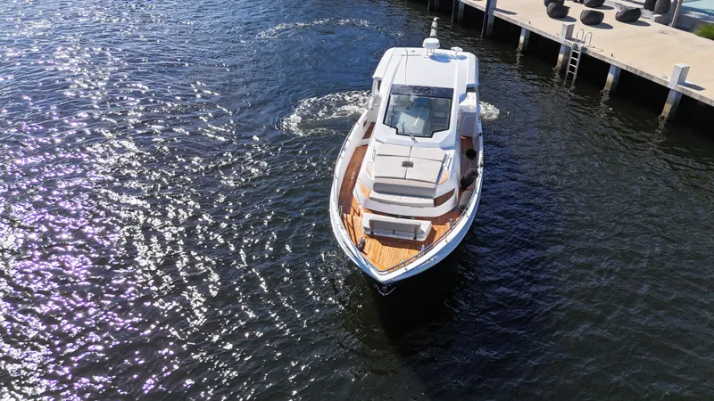 Slide: The Image of 2018 Azimut Verve 40 yacht cruising near a dock on a sunny day. - 8