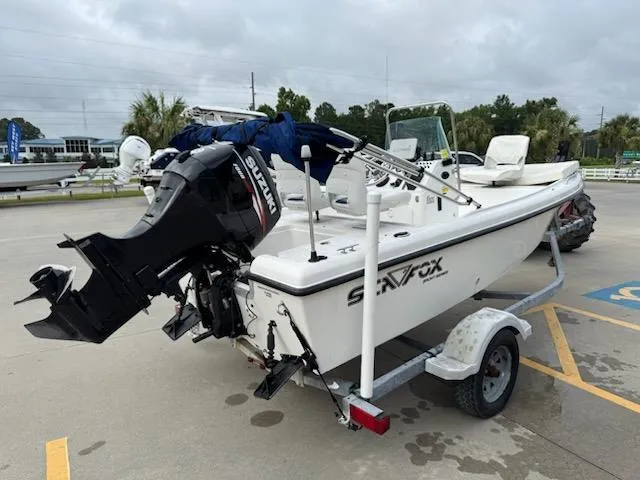Slide: The Image of 2007 Sea Fox 16CC boat with Suzuki outboard motor on trailer, parked outdoors. - 3