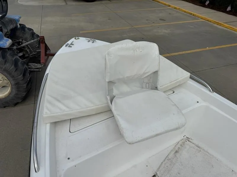 Slide: The Image of 2007 Sea Fox 16CC boat with white seating, parked on concrete surface. - 8