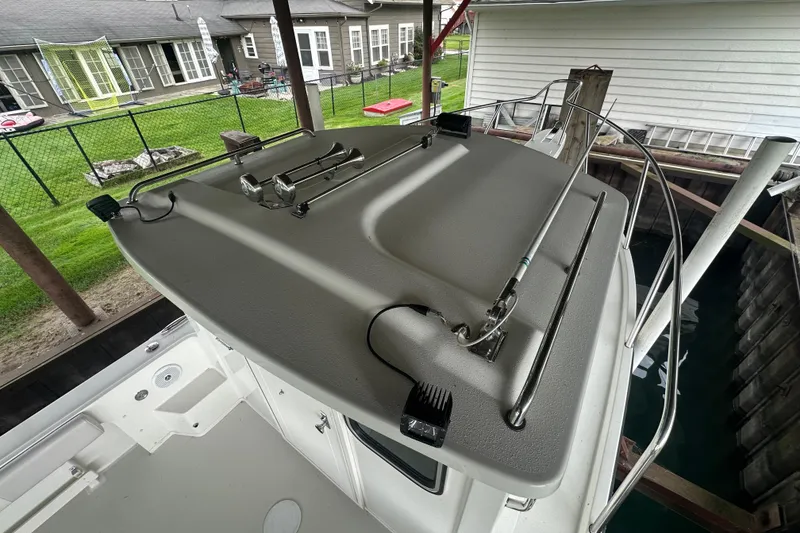 Slide: The Image of 2016 Parker 2320 SL Sport Cabin boat roof with railing and equipment. - 12
