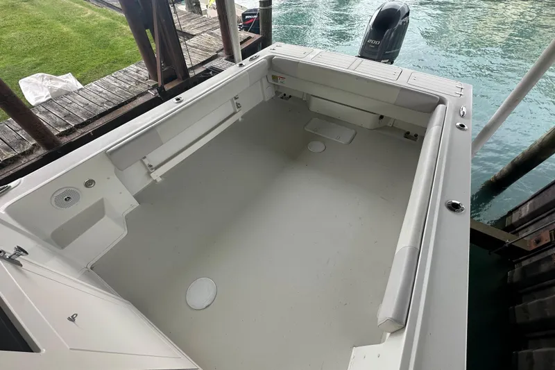 Slide: The Image of 2016 Parker 2320 SL Sport Cabin boat interior with spacious deck and outboard motor. - 15
