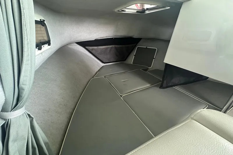 Slide: The Image of 2016 Parker 2320 SL Sport Cabin interior with cushioned seating and window view. - 20