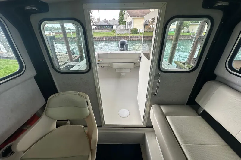 Slide: The Image of Interior view of 2016 Parker 2320 SL Sport Cabin, showing seating and rear deck access. - 21