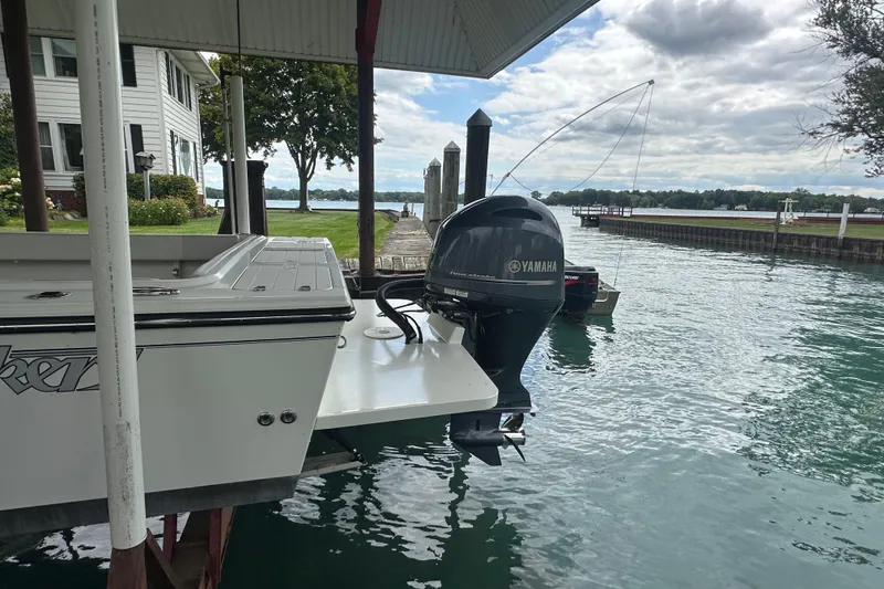 Slide: The Image of 2016 Parker 2320 SL Sport Cabin boat docked with Yamaha outboard motor. - 6