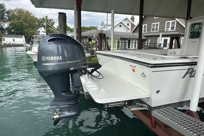 Slide: The Image of 2016 Parker 2320 SL Sport Cabin with Yamaha outboard motor docked by waterfront homes. - 7