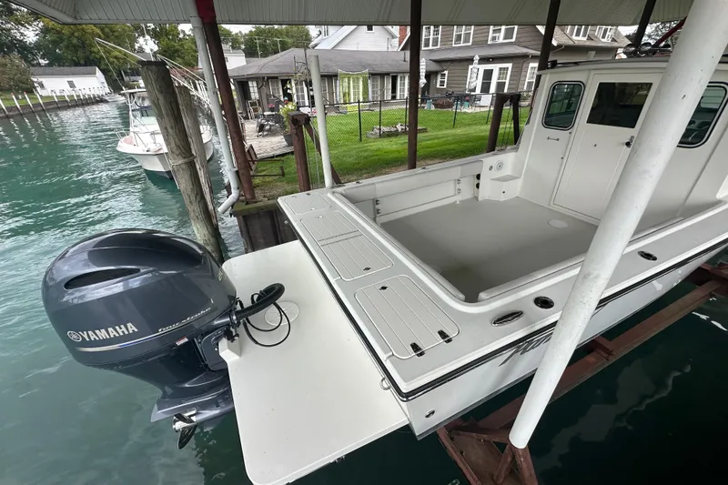 Slide: The Image of 2016 Parker 2320 SL Sport Cabin boat with Yamaha outboard motor docked by waterfront. - 8