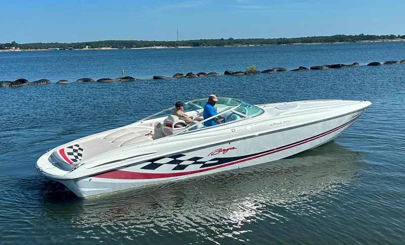 Slide: The Image of 2000 Baja 342 speedboat cruising on a calm lake with two passengers. - 11