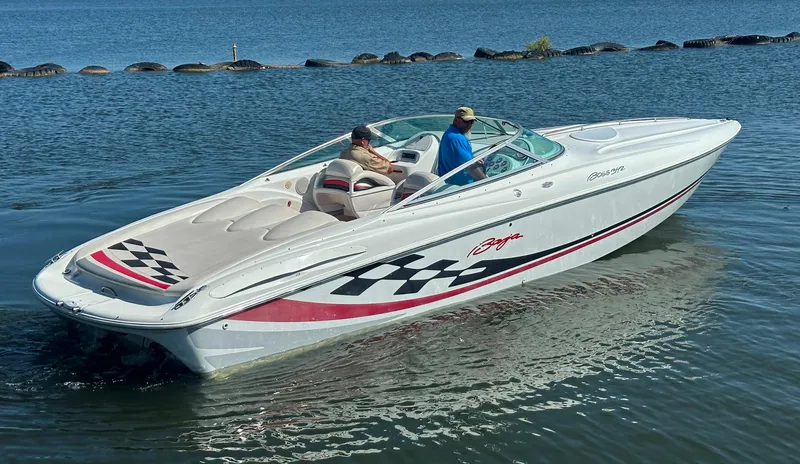 Slide: The Image of 2000 Baja 342 speedboat on water, featuring sleek design and checkered graphics. - 12