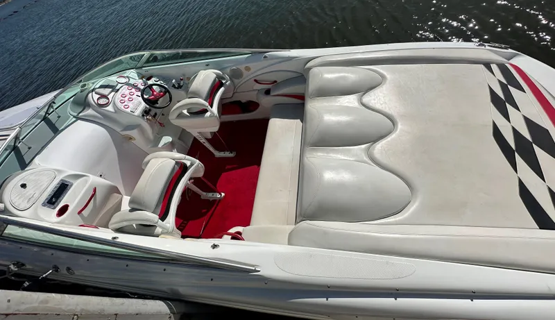 Slide: The Image of 2000 Baja 342 boat interior with white seating, red accents, and a sleek dashboard on the water. - 15