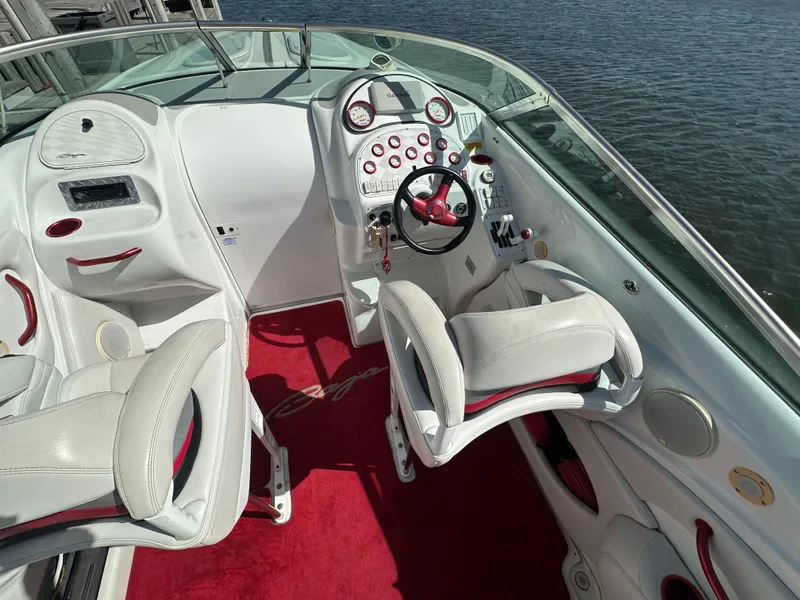 Slide: The Image of Interior of a 2000 Baja 342 boat with white seats and red accents. - 16