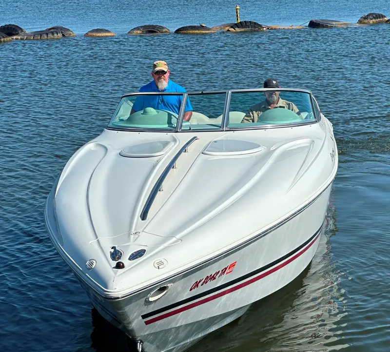 Slide: The Image of 2000 Baja 342 boat on water with two people onboard, sunny day. - 2