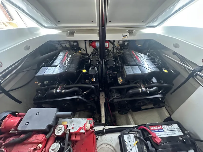 Slide: The Image of Engine compartment of a 2000 Baja 342 boat with dual Mercury engines. - 25
