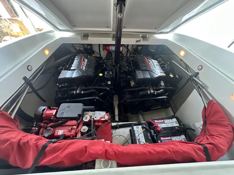 Slide: The Image of Engine compartment of a 2000 Baja 342 boat with dual Mercury engines and Duralast batteries. - 26