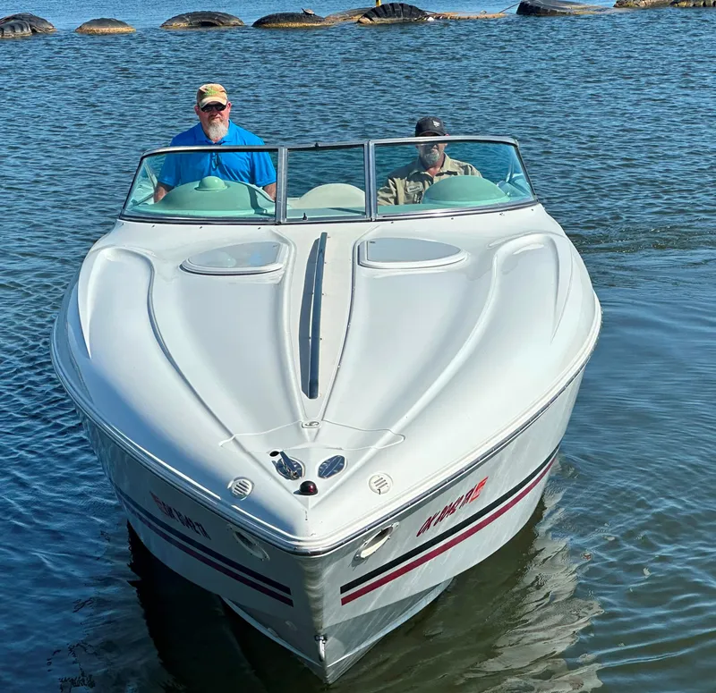 Slide: The Image of Two people on a 2000 Baja 342 boat in calm waters. - 3
