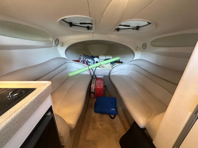 Slide: The Image of Interior of a 2000 Baja 342 boat cabin with seating and storage items. - 31
