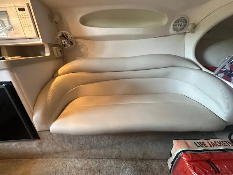 Slide: The Image of Interior of a 2000 Baja 342 boat with white leather seating and life jackets. - 34