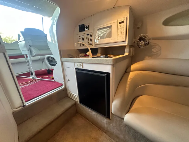 Slide: The Image of Interior of a 2000 Baja 342 boat with kitchenette and seating area. - 35