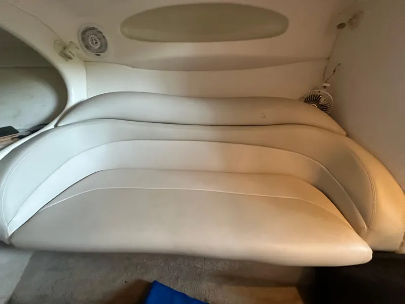 Slide: The Image of Interior seating of a 2000 Baja 342 boat, featuring white cushioned seats. - 36