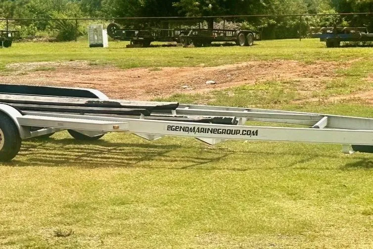 Slide: The Image of Boat trailer on grass, featuring "legendmarinegroup.com" text, suitable for Baja 342 model. - 42