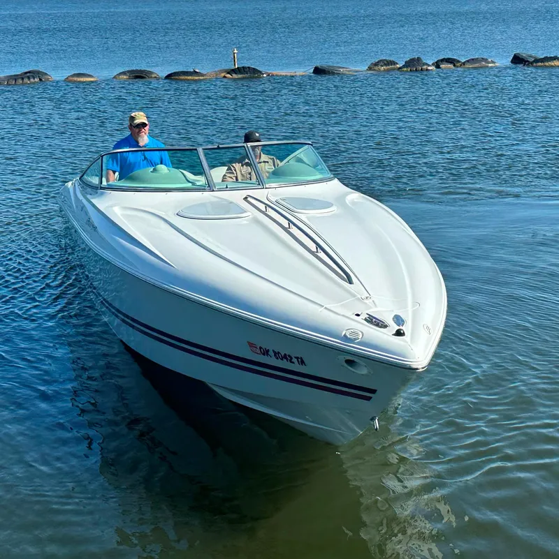 Slide: The Image of 2000 Baja 342 boat cruising on calm water with two passengers. - 5