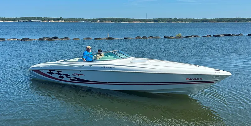 Slide: The Image of 2000 Baja 342 speedboat on a calm lake with two people onboard. - 8