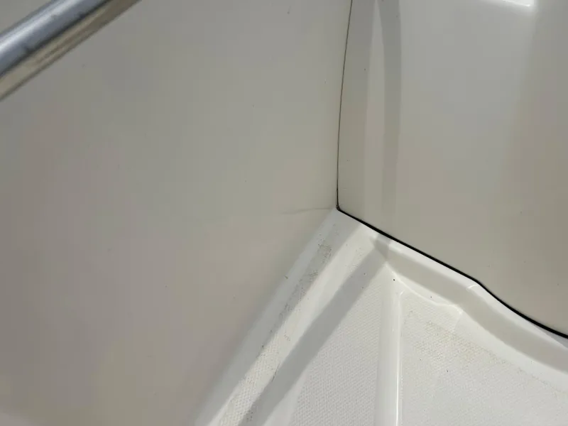 Slide: The Image of 2018 Boston Whaler 130 Super Sport interior corner detail, showcasing clean white surface. - 14