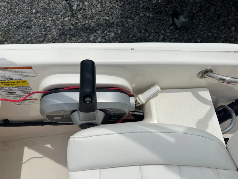Slide: The Image of 2018 Boston Whaler 130 Super Sport boat interior with control panel and seating. - 16