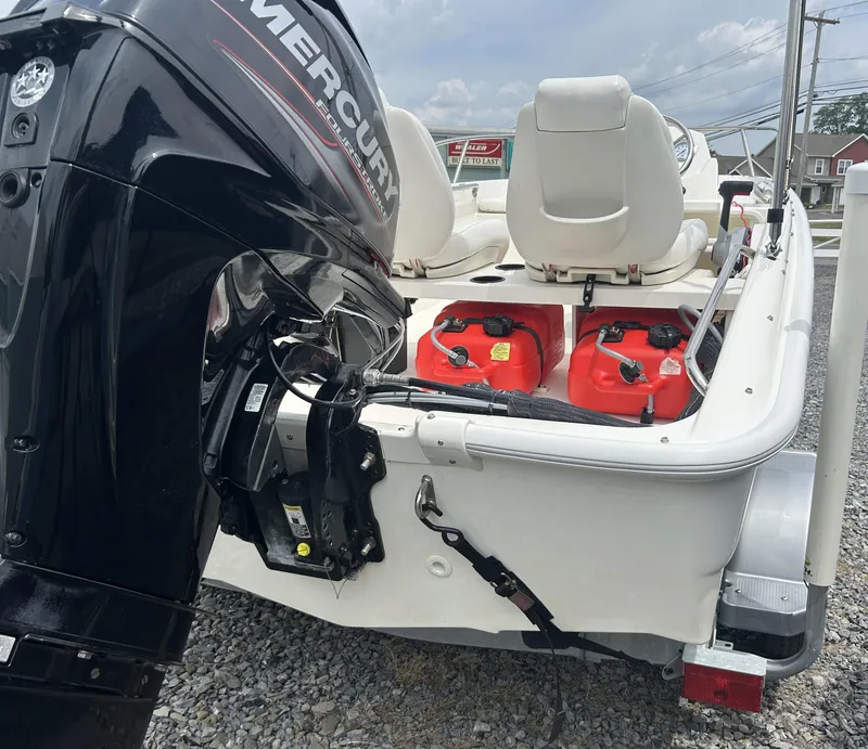 Slide: The Image of 2018 Boston Whaler 130 Super Sport with Mercury outboard motor and red fuel tanks. - 8