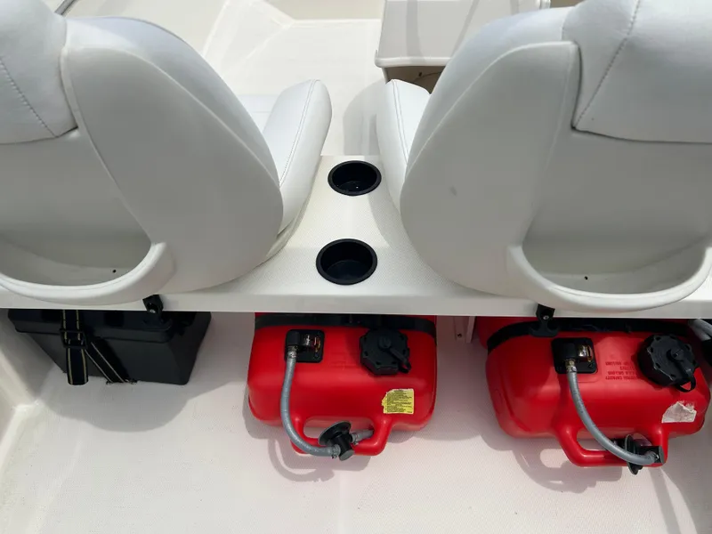 Slide: The Image of 2018 Boston Whaler 130 Super Sport interior with dual seats and red fuel tanks. - 9