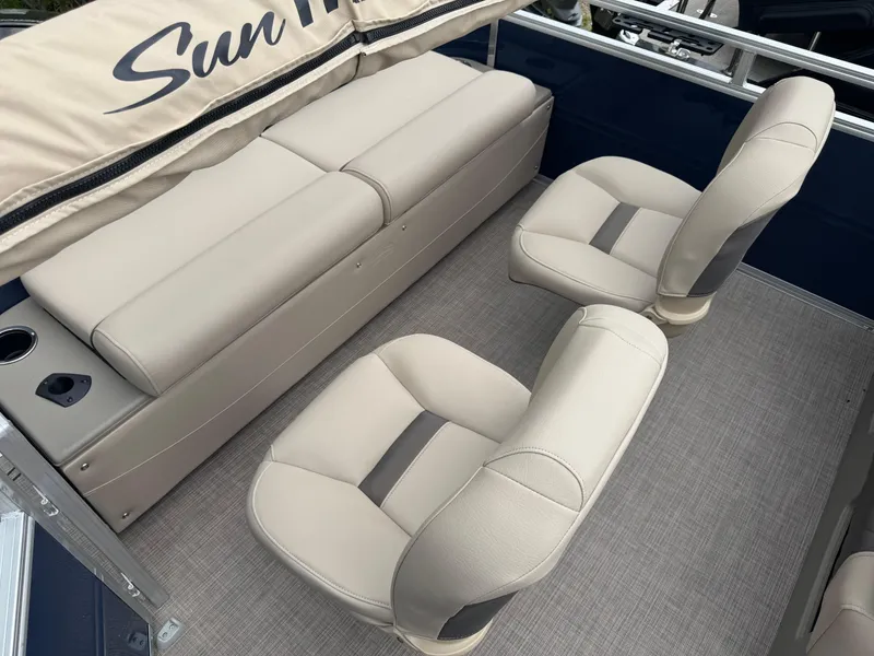 Slide: The Image of 2025 Sun Tracker Fishin' Barge 22 XP3 interior with beige seating and carpeted floor. - 15