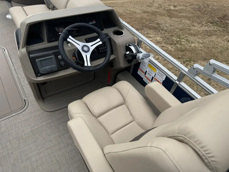 Slide: The Image of 2025 Sun Tracker Fishin' Barge 22 XP3 steering console with beige captain's chair. - 16