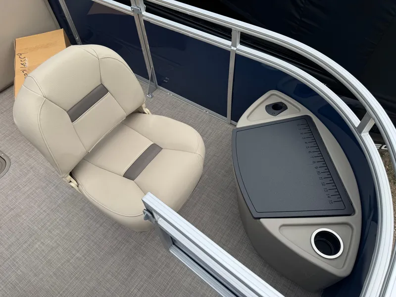 Slide: The Image of 2025 Sun Tracker Fishin' Barge 22 XP3 interior with beige seat and fishing station. - 7