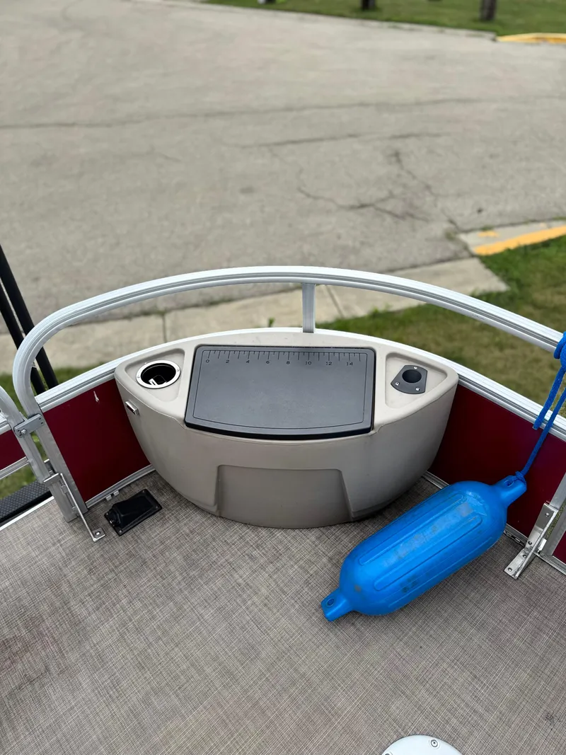 Slide: The Image of 2022 Sun Tracker Bass Buggy 18 DLX boat deck with storage and blue fender. - 12