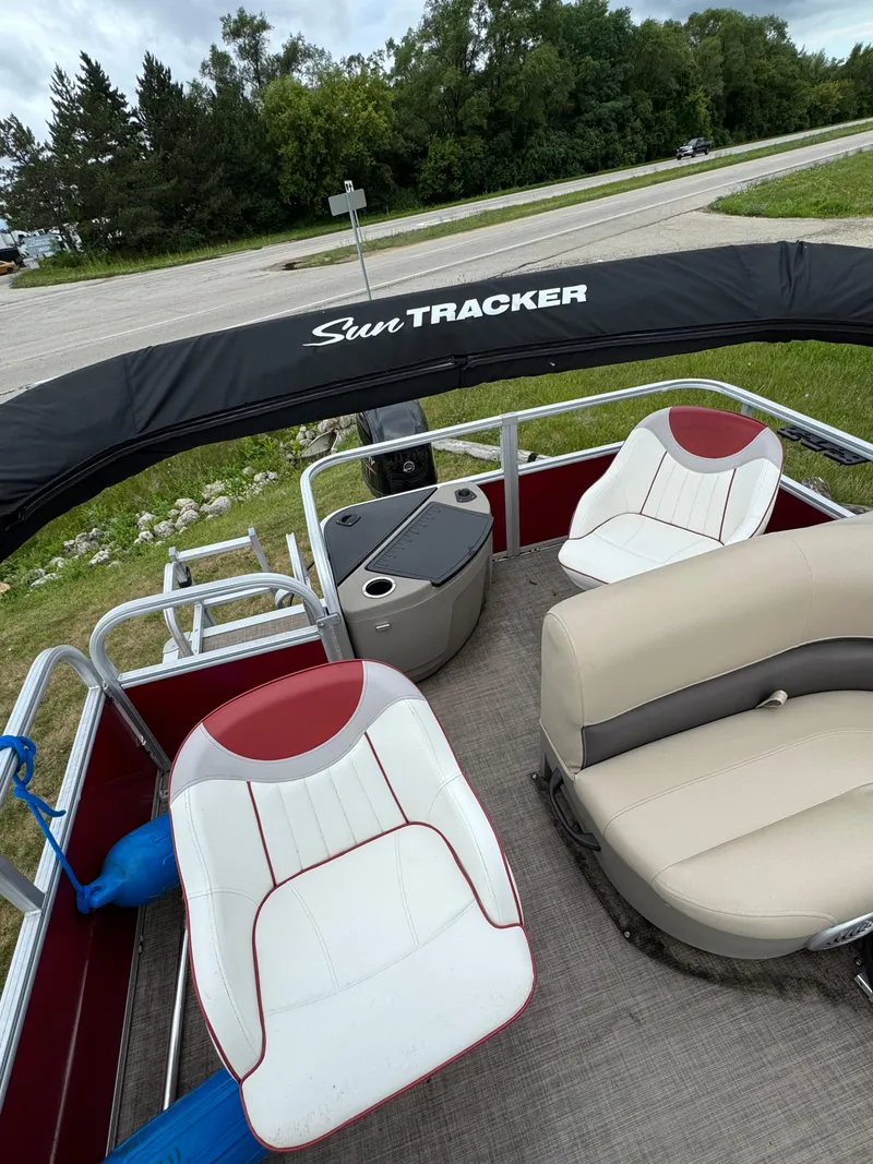 Slide: The Image of 2022 Sun Tracker Bass Buggy 18 DLX pontoon boat interior with seating and canopy. - 19