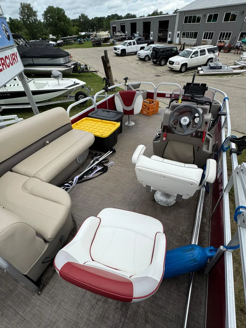 Slide: The Image of 2022 Sun Tracker Bass Buggy 18 DLX pontoon boat interior with seating and steering console. - 20