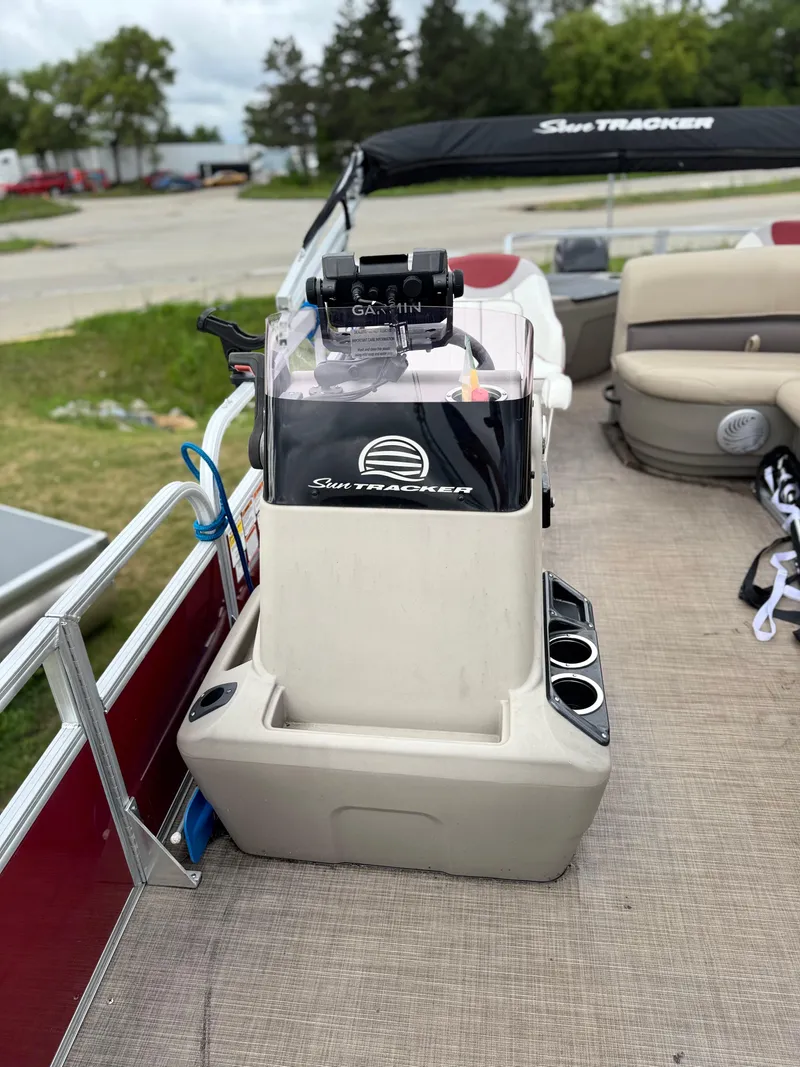 Slide: The Image of 2022 Sun Tracker Bass Buggy 18 DLX pontoon boat interior with seating and console. - 22