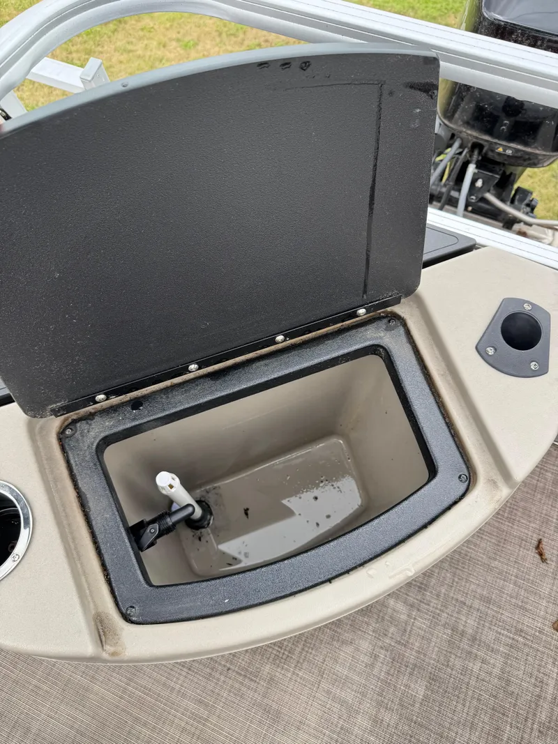 Slide: The Image of Open storage compartment on 2022 Sun Tracker Bass Buggy 18 DLX boat. - 23