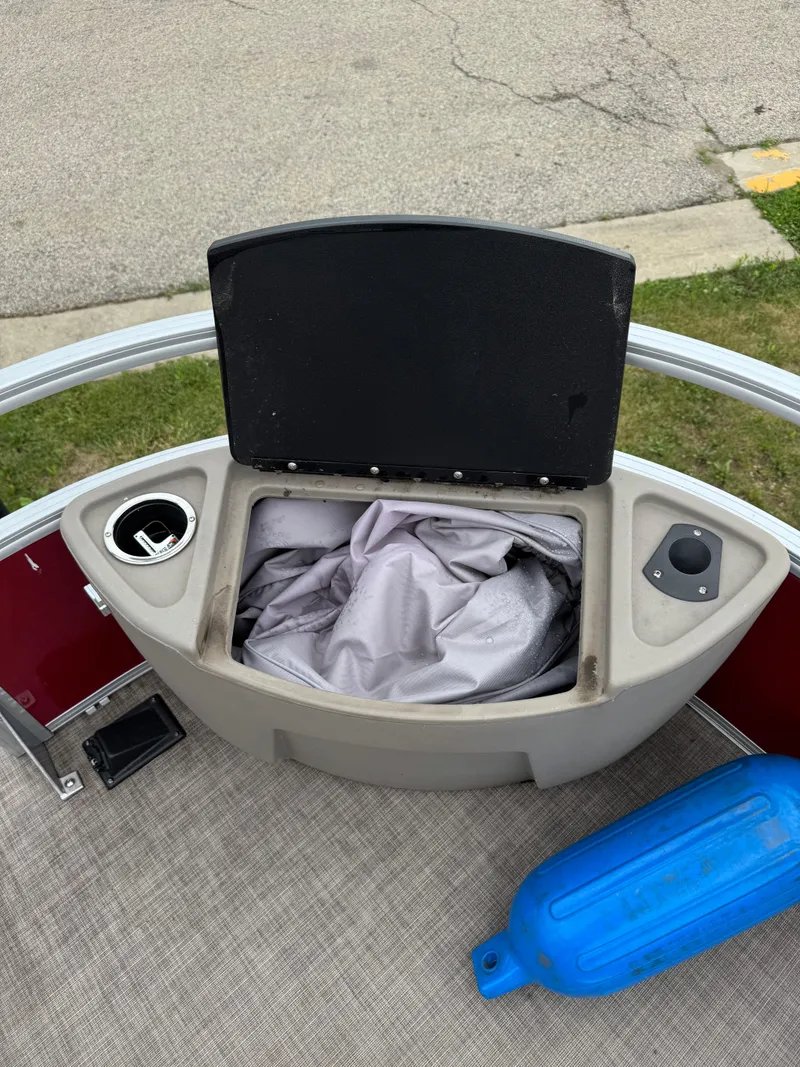 Slide: The Image of 2022 Sun Tracker Bass Buggy 18 DLX storage compartment with cover and cup holder. - 25
