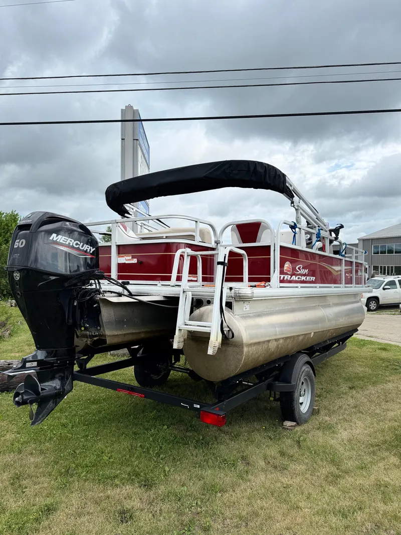Slide: The Image of 2022 Sun Tracker Bass Buggy 18 DLX pontoon boat with Mercury engine on trailer. - 9